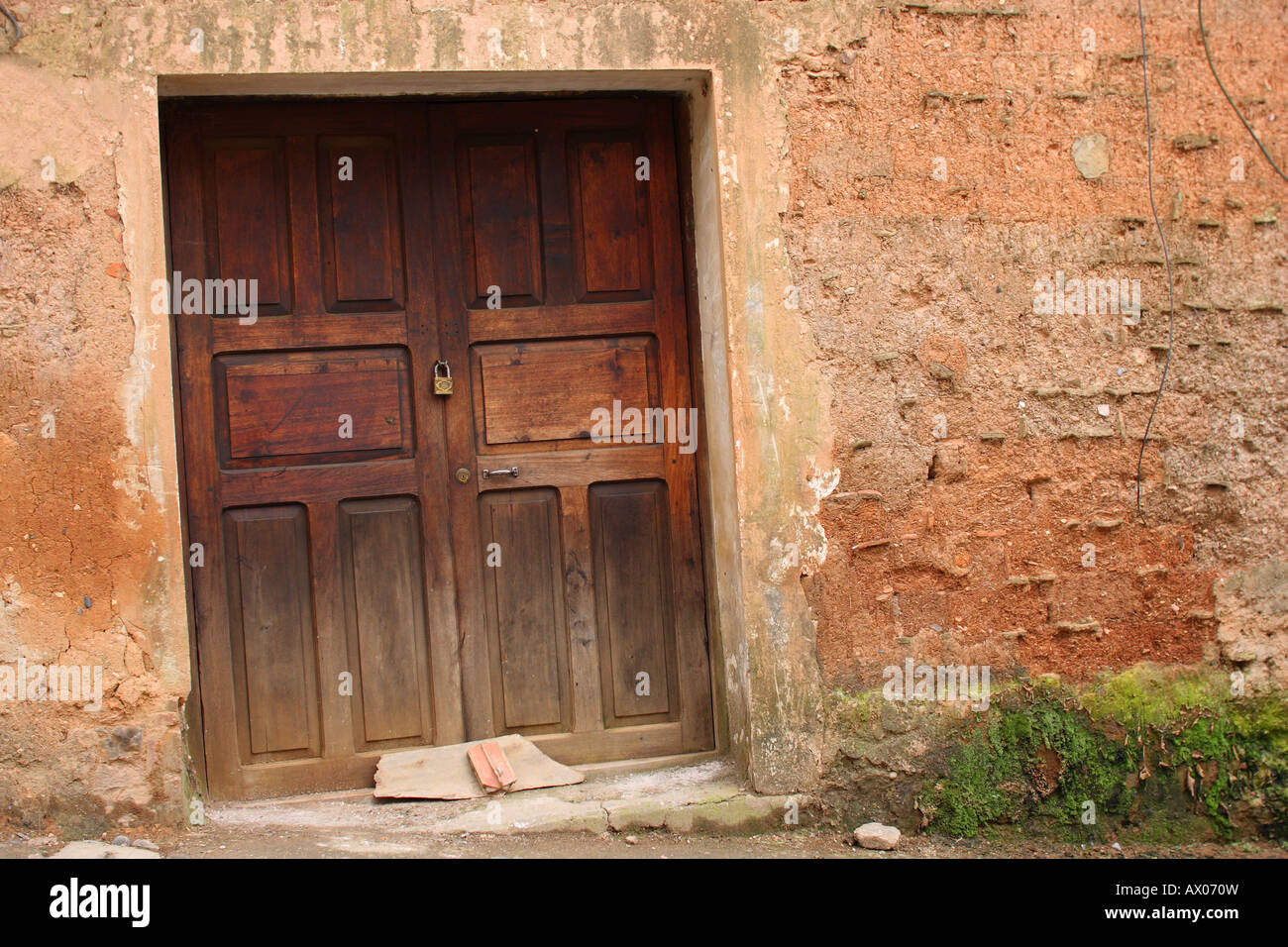 A closed, locked, old wooden door of a building in Coroico, Bolivia. Stock Photo