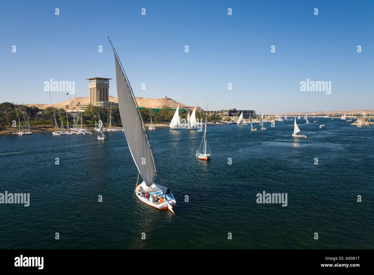 Felucca boats sailing on the River Nile in front of Hotel Oberoi in Aswan Upper Egypt North Africa Middle East Stock Photo