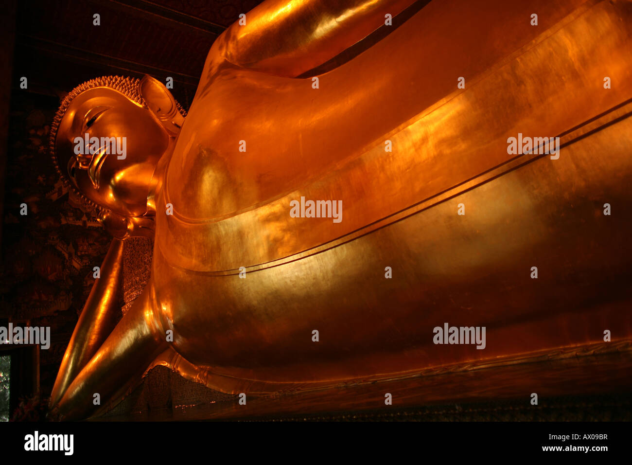 The golden Reclining Buddha statue in the holy temple Wat Pho near Bangkok Stock Photo