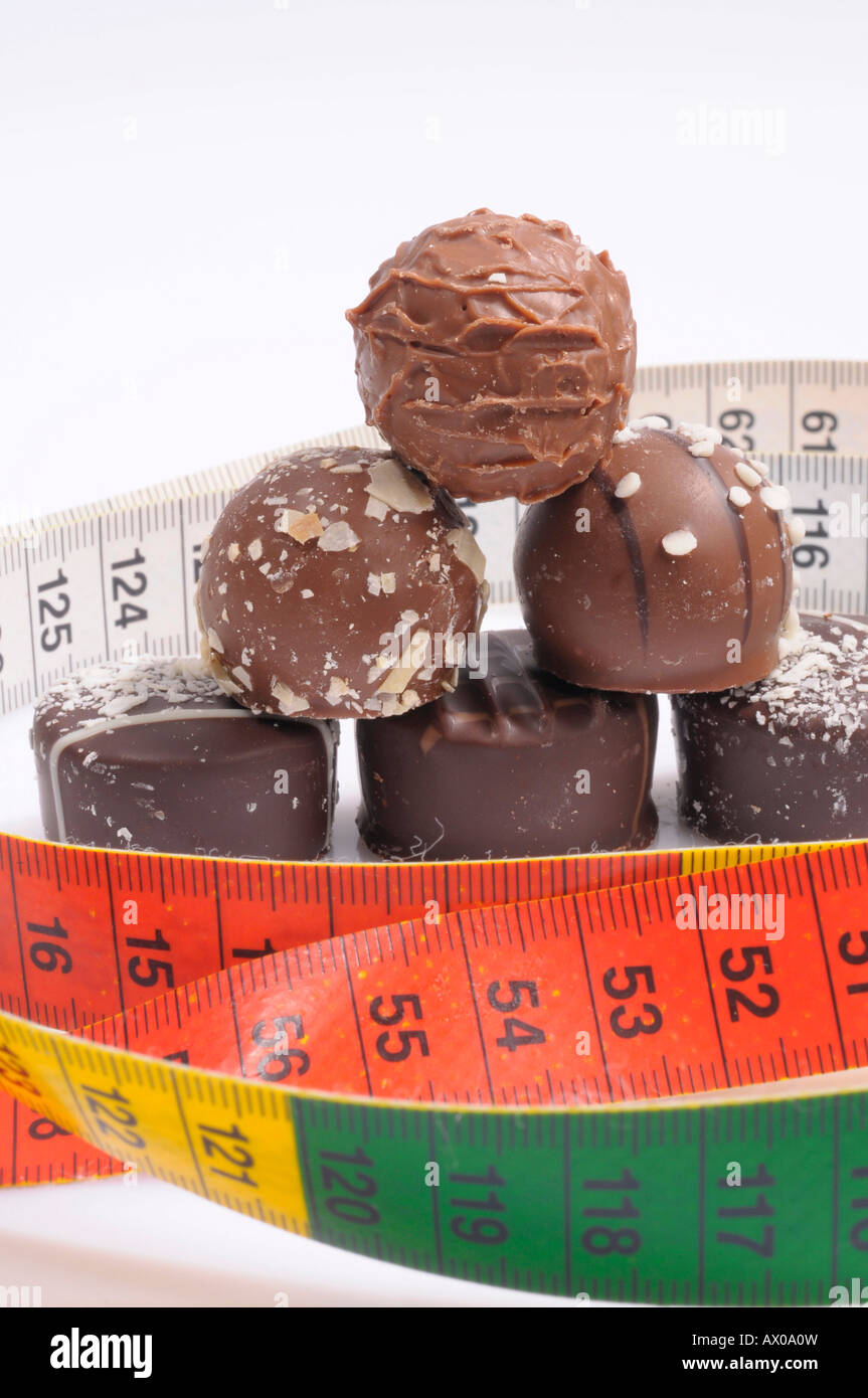 Chocolate pralines and a measuring tape Stock Photo