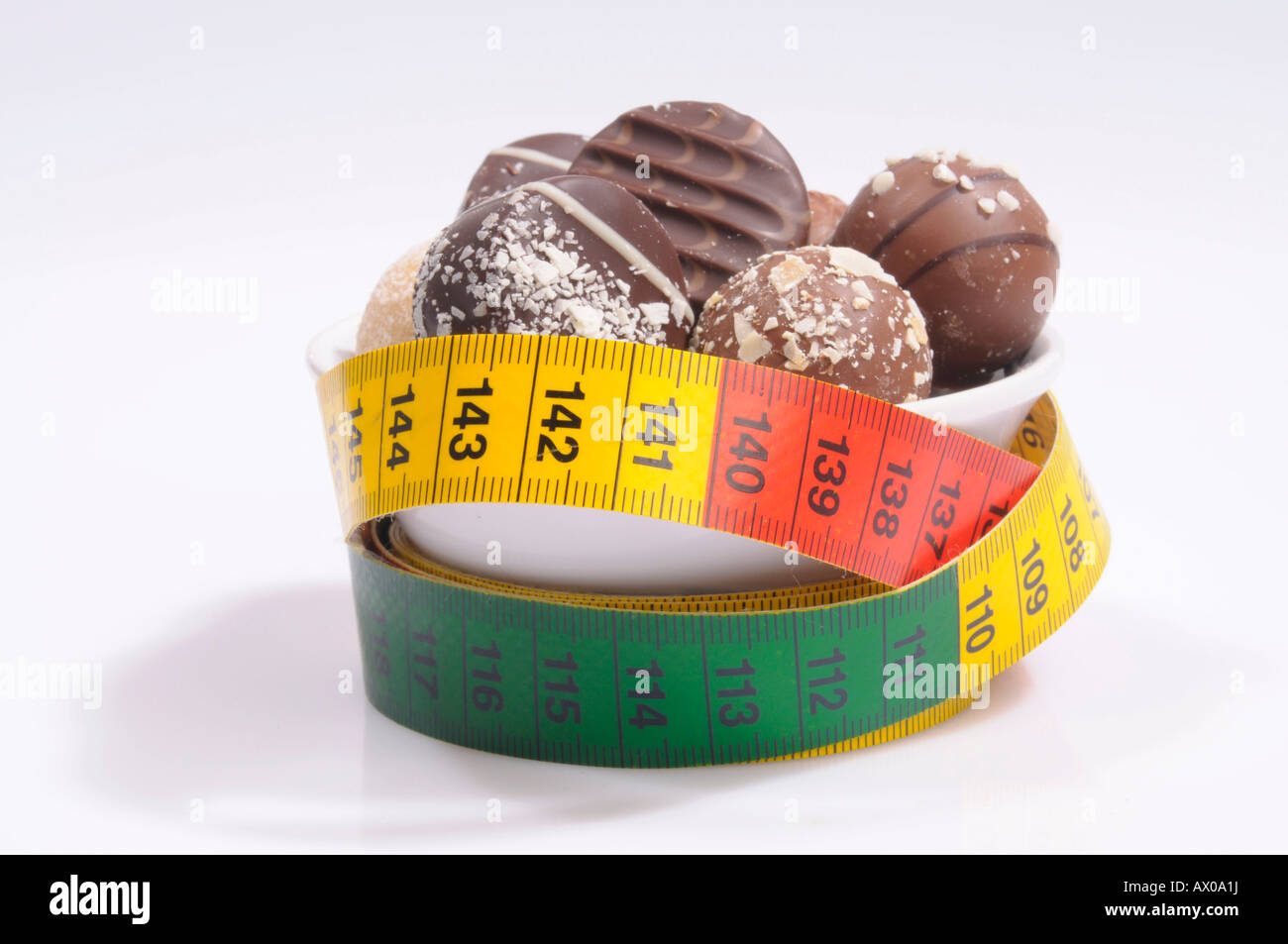 Chocolate pralines and a measuring tape Stock Photo
