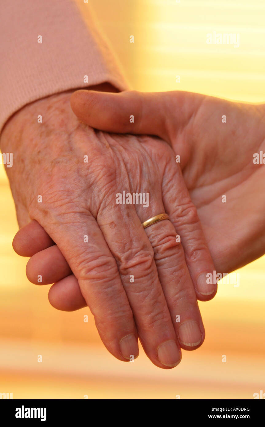Woman younger man holding hands hi-res stock photography and images - Alamy