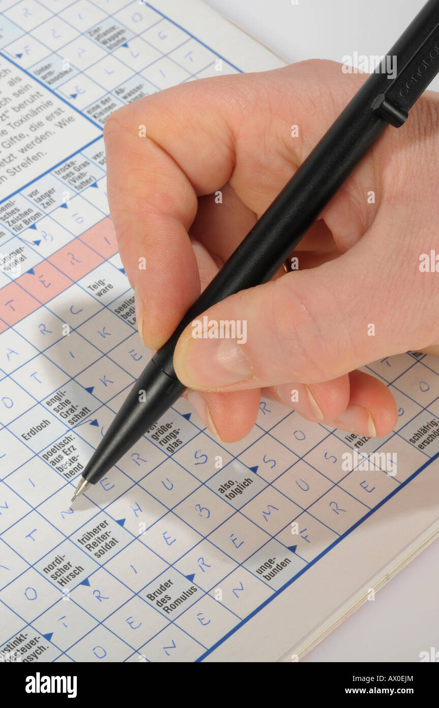 Woman doing a crossword puzzle Stock Photo