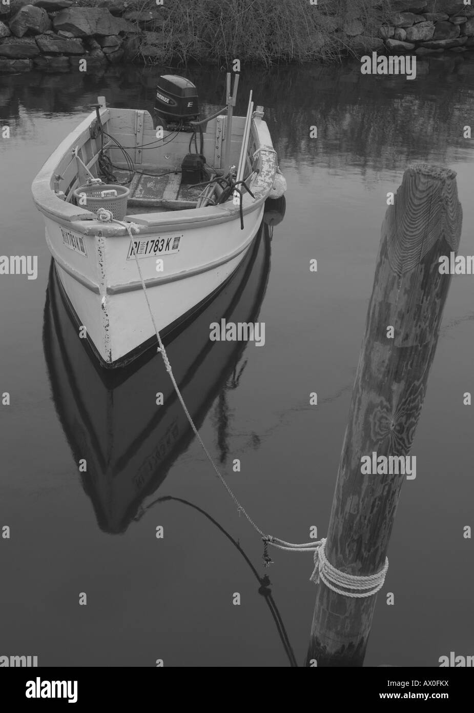 A small work skiff tied to the dock Stock Photo