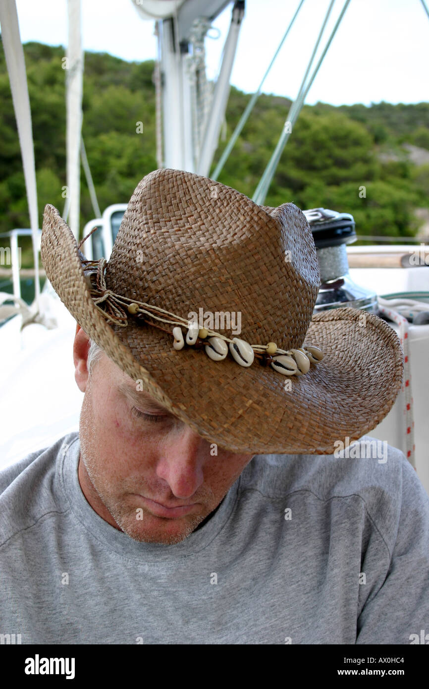Man in straw hat on yacht Stock Photo 