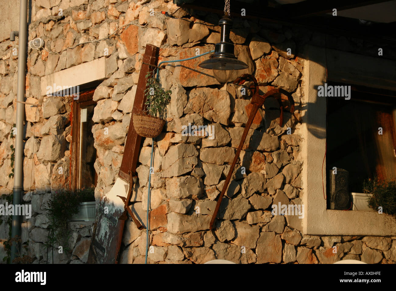 Old Stone house wall with farm instruments Stock Photo - Alamy