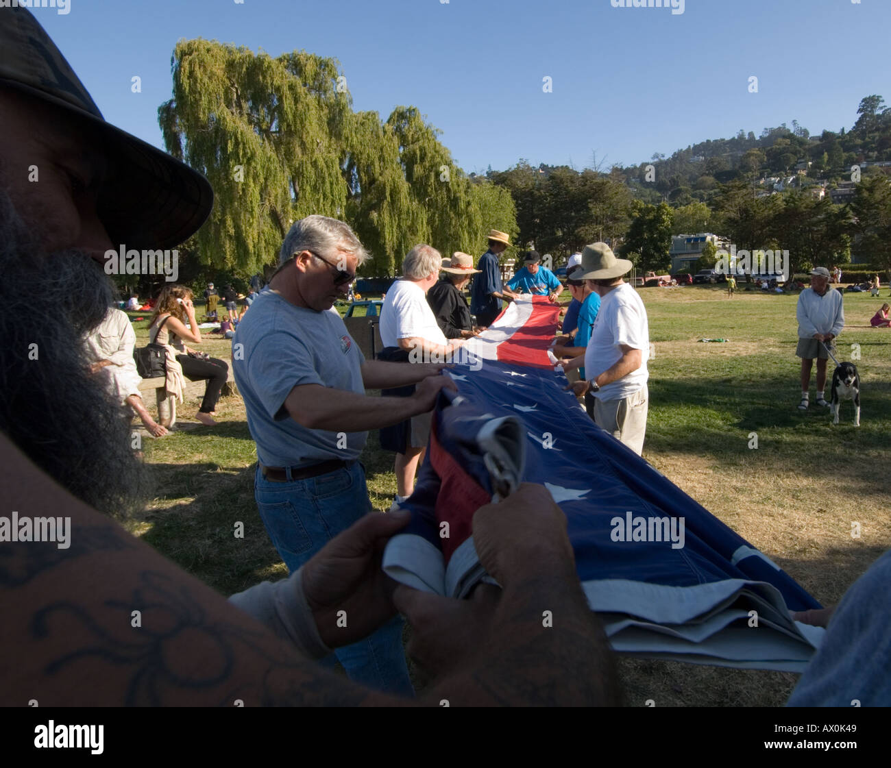 People folding the flag in the traditional manner on the 4th of July holiday in Sausalito,California,USA Stock Photo