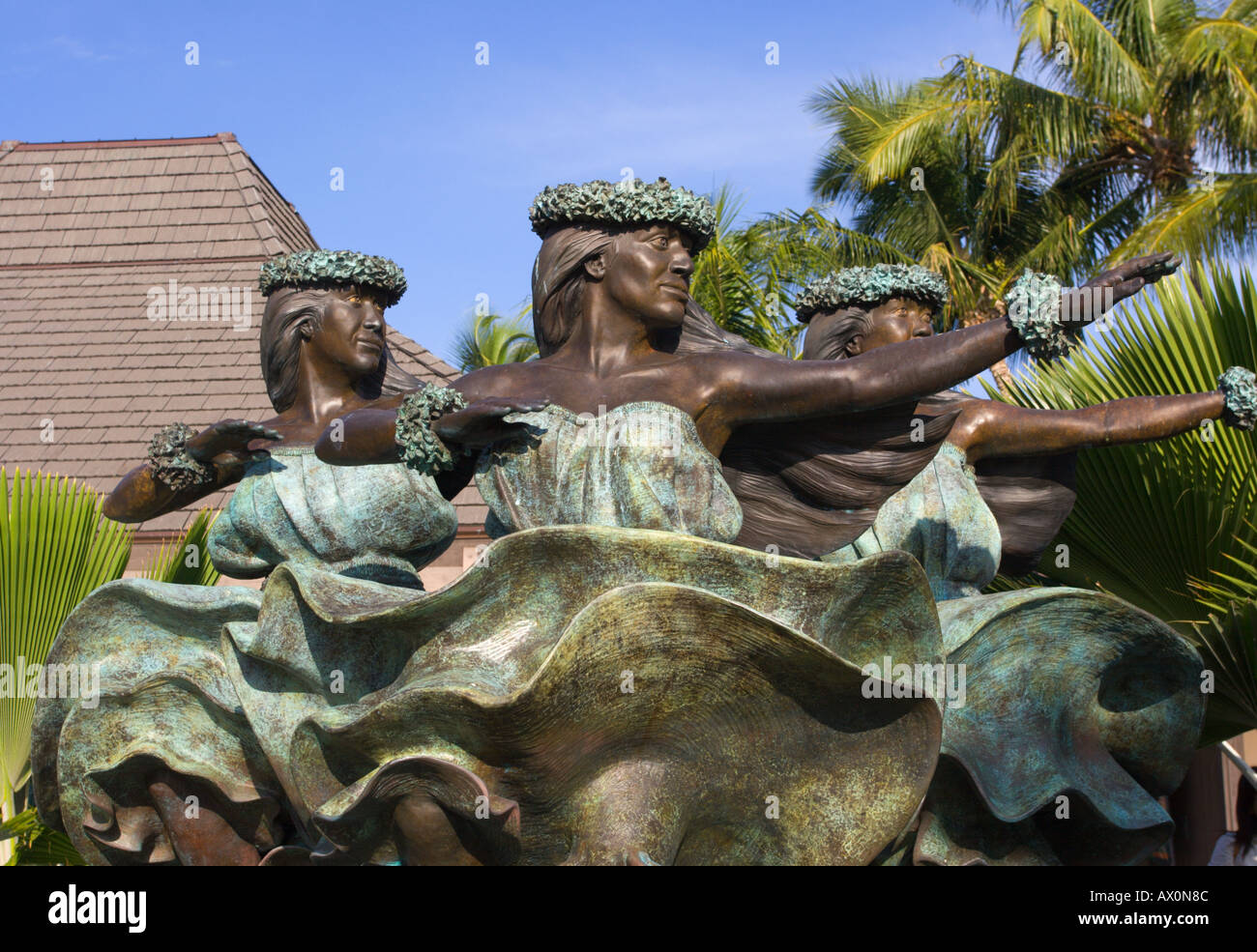 Lovely bronze statue of Hawaiian dancing trio at Keahole Kona International Airport Big Island Hawaii Stock Photo