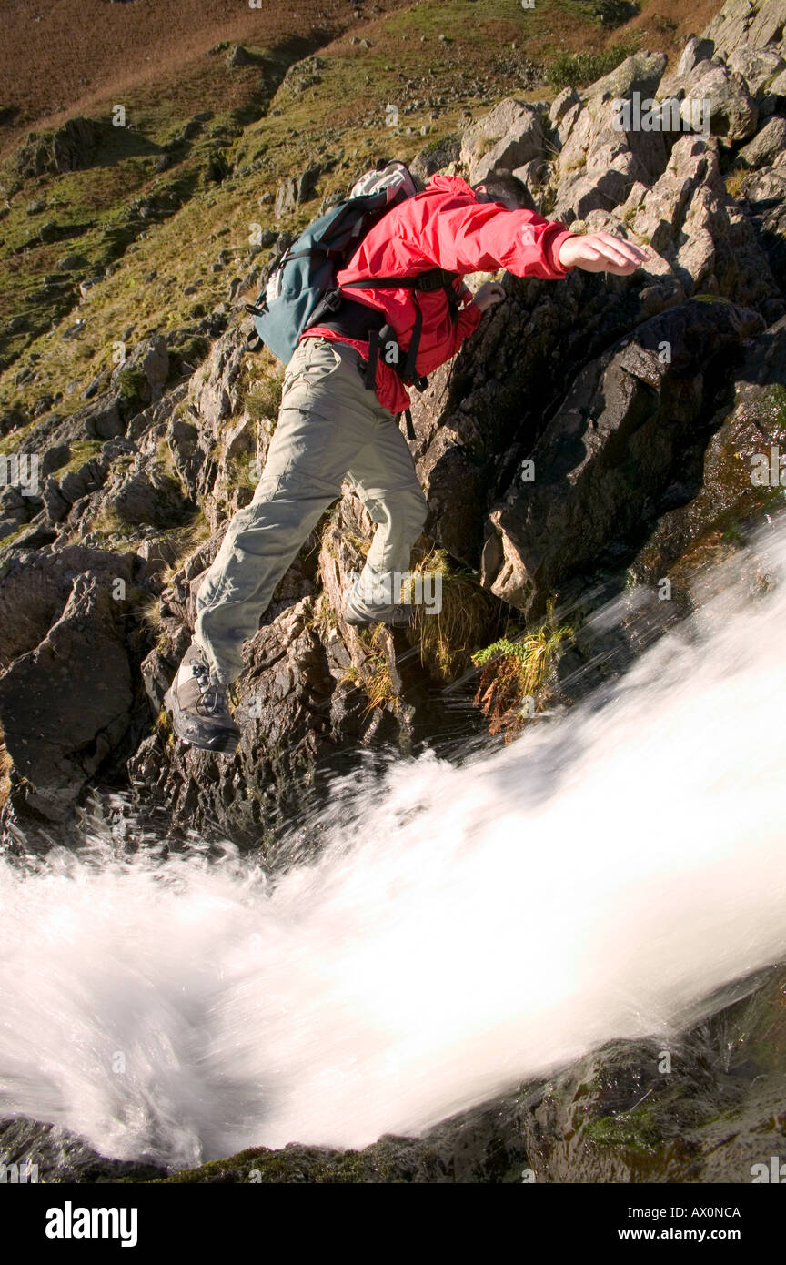 hill walker climbing up Stickle Ghyll in the Langdale Valley, Lake district, Cumbria, UK Stock