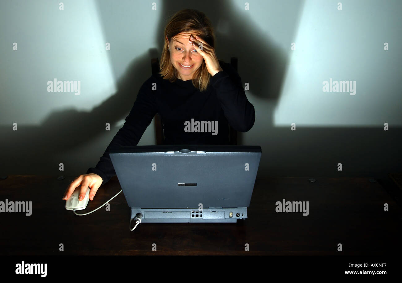 woman working at laptop computer with stress Stock Photo - Alamy