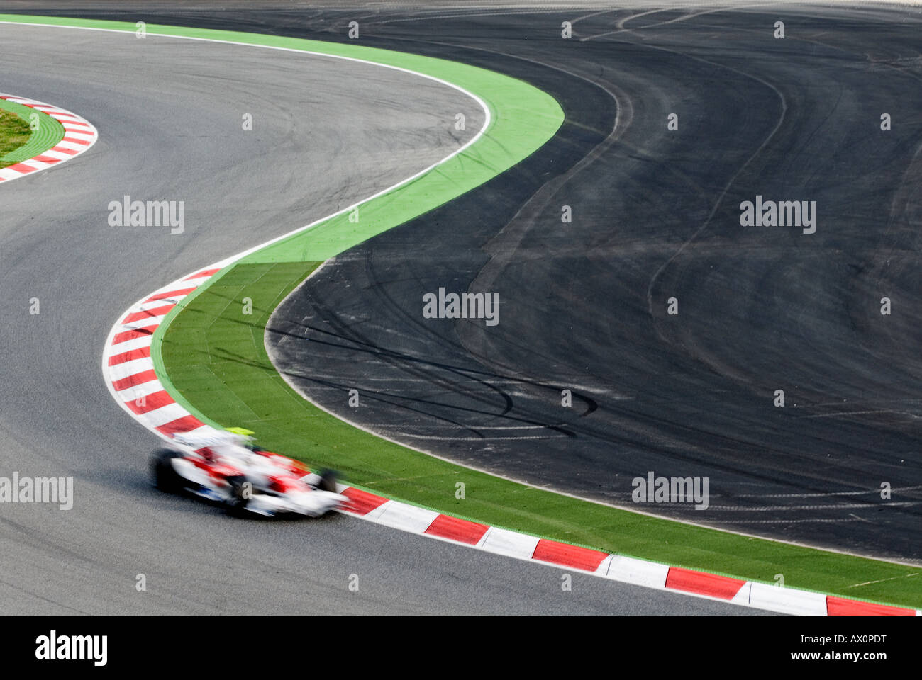 Formula 1 Racecar speeds through double bend curve in racetrack Stock ...