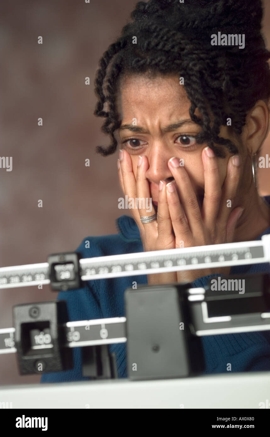 African American woman shocked at weight gain Stock Photo