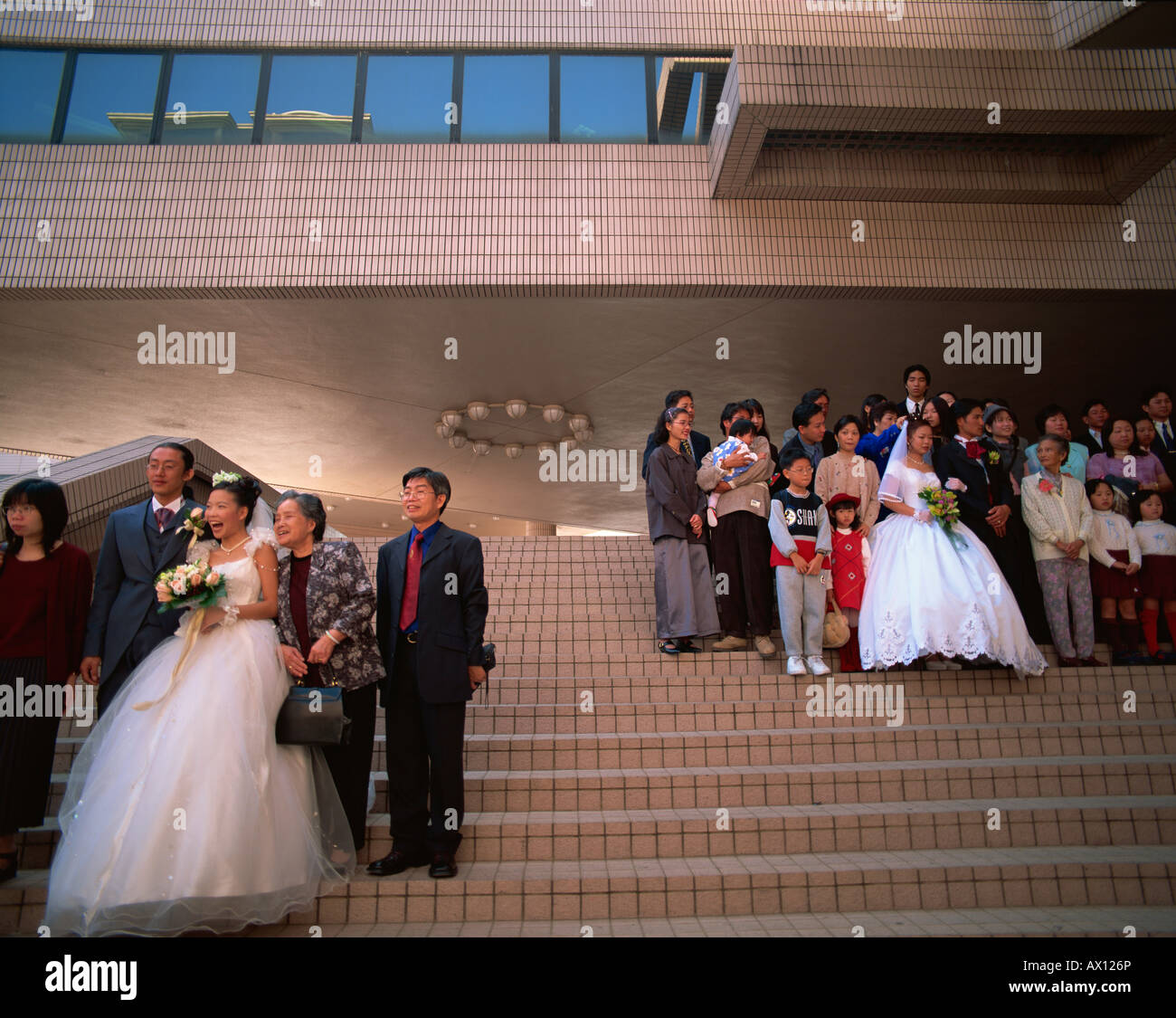 China, Hong Kong, Kowloon, Tsim Sha Tsui, Wedding Groups in front of the Hong Kong Cultural Centre Stock Photo