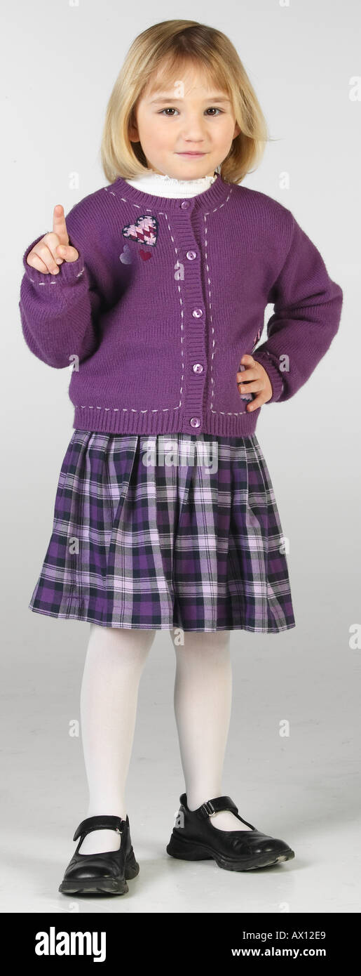 Smiling little girl in purple skirt and sweater uid 1459600 Stock Photo ...