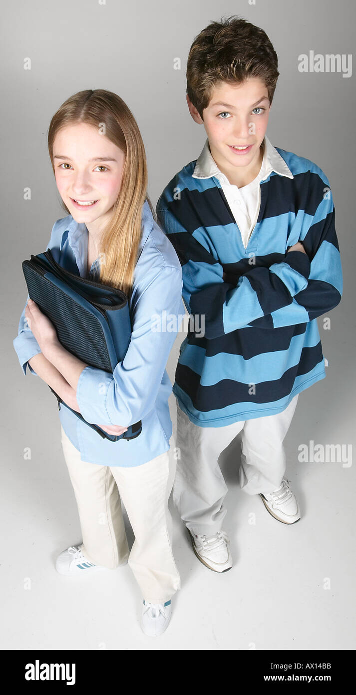 Smiling boy and girl standing holding school book Stock Photo - Alamy