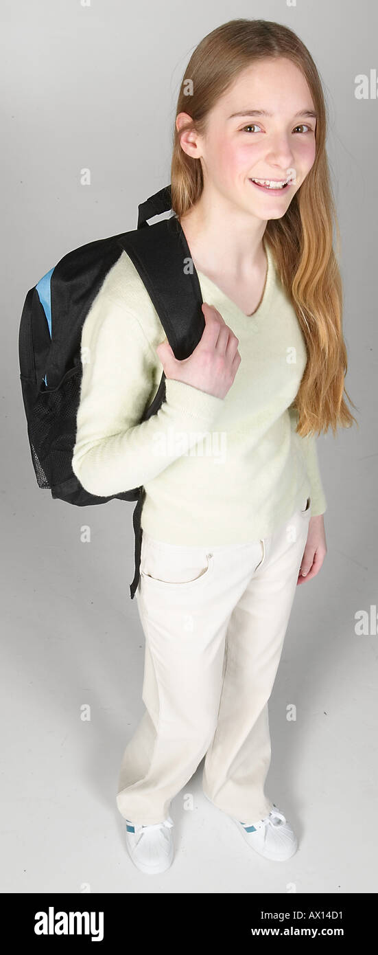 Smiling teenaged girl carrying backpack Stock Photo - Alamy