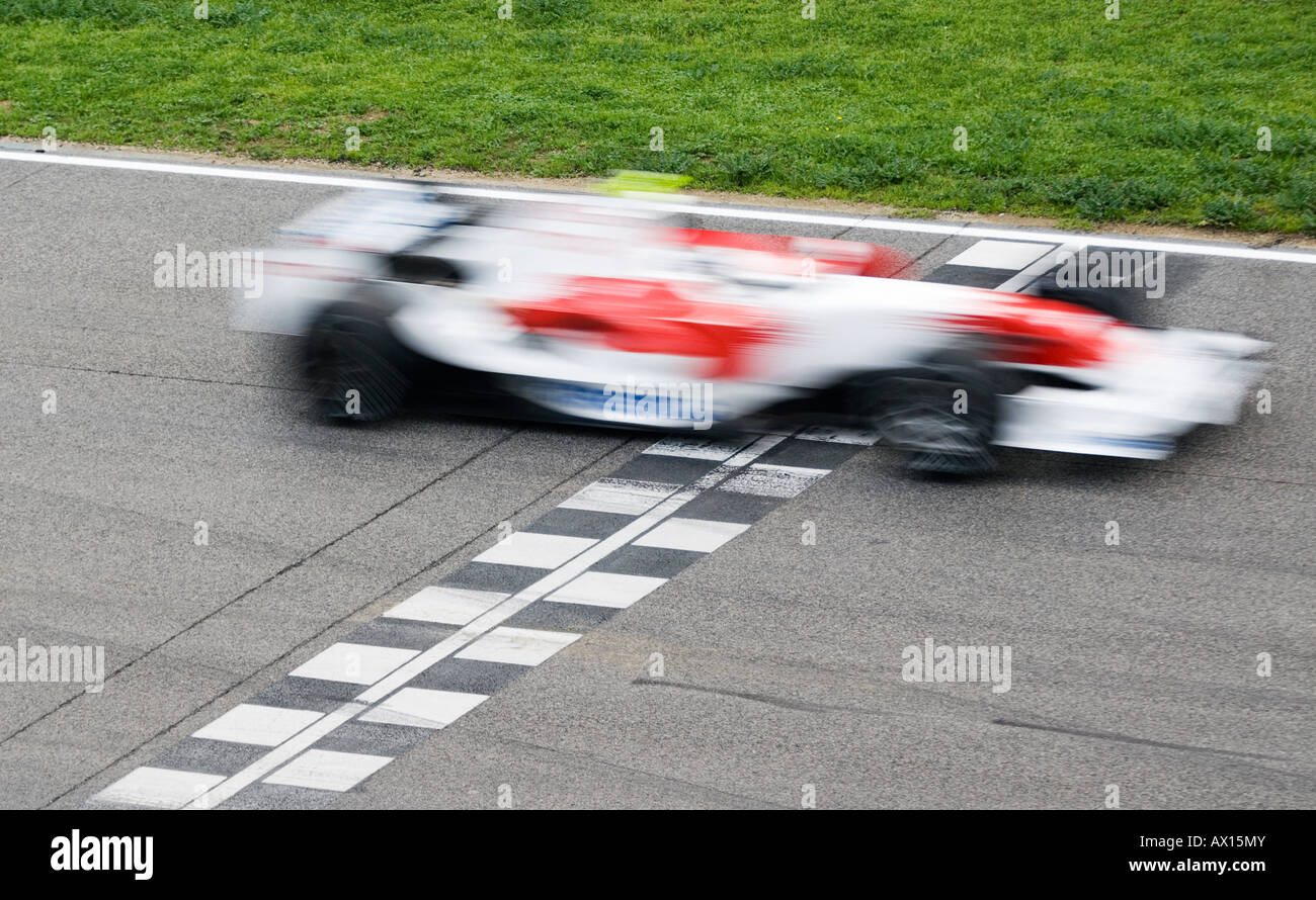 red and white Toyota Formula 1 racecar crosses the finish line Stock Photo