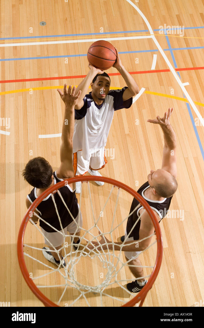 Three young men playing basketball Stock Photo Alamy