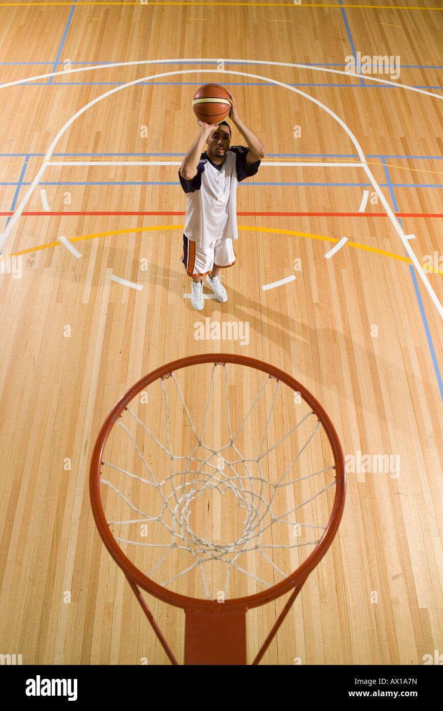 A young man about to shoot a basket Stock Photo