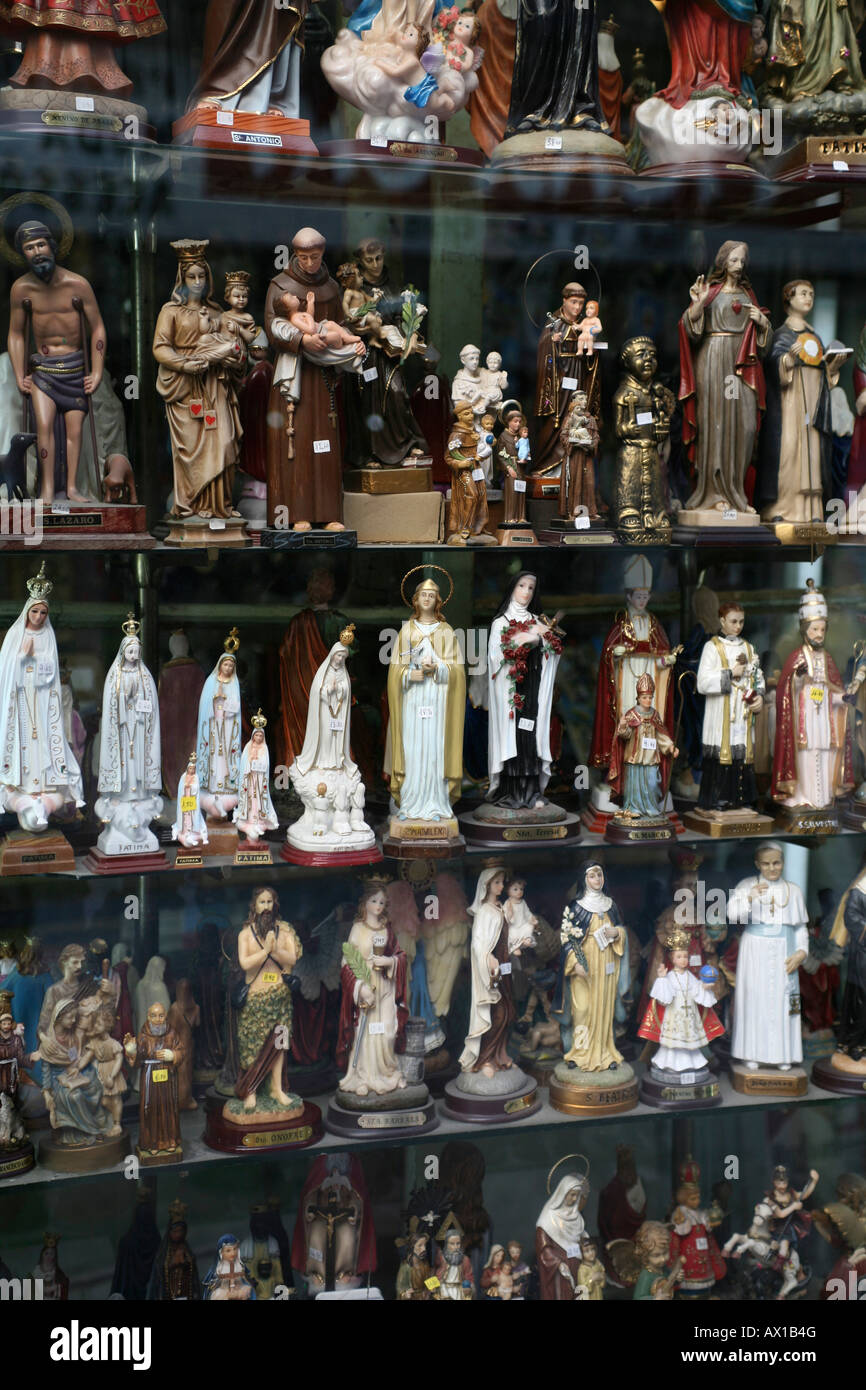 Window display of religious statues Stock Photo Alamy