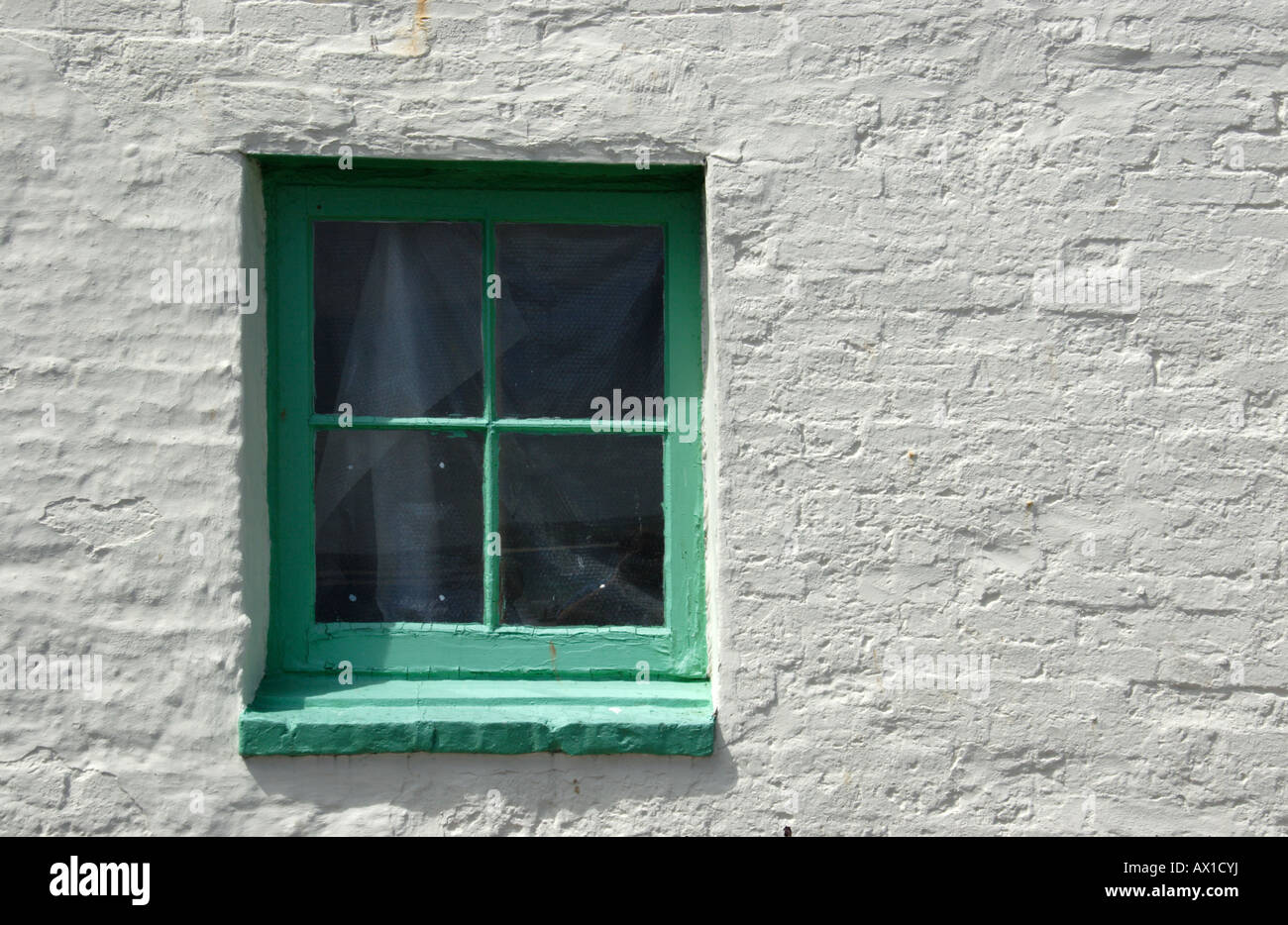 Green framed window on white wall, St Ives, South Cornwall, UK. Stock Photo