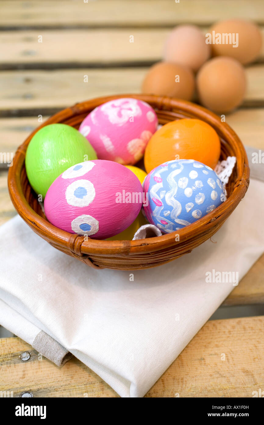 Hand-painted Easter eggs in a brown bamboo bowl Stock Photo