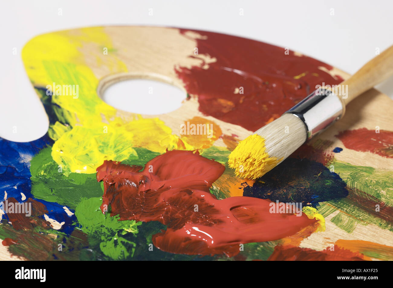 Paintbrush mixing paint colors Stock Photo Alamy