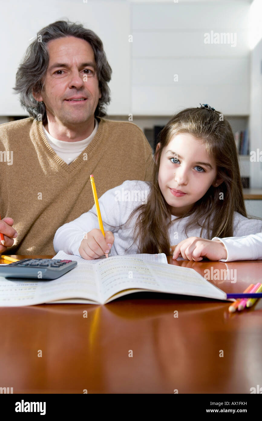 A father helping his daughter with her homework Stock Photo - Alamy