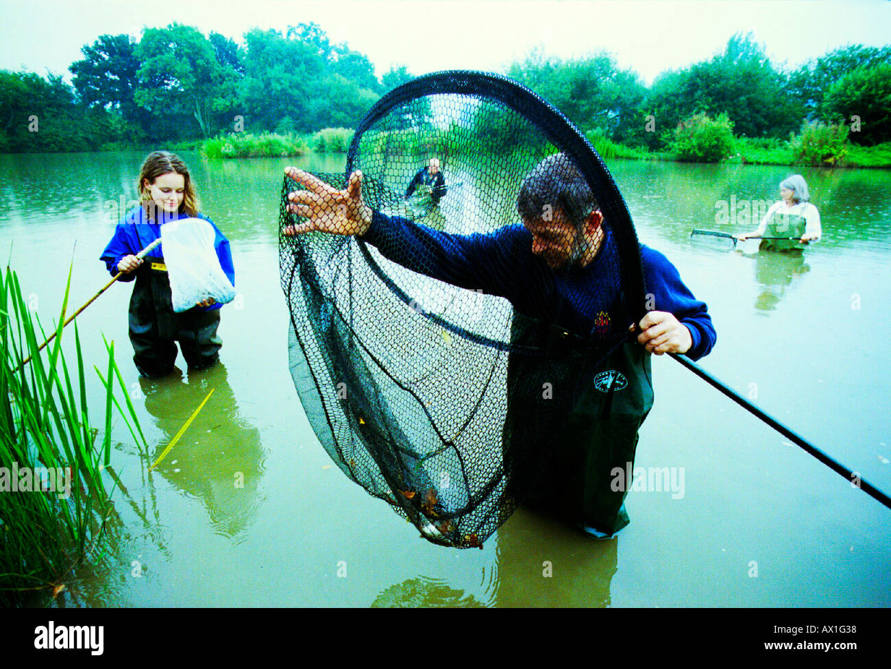 A conservation worker monitors wildlife in a country village as part of a project funded by Southern Water to preserve ponds. Stock Photo