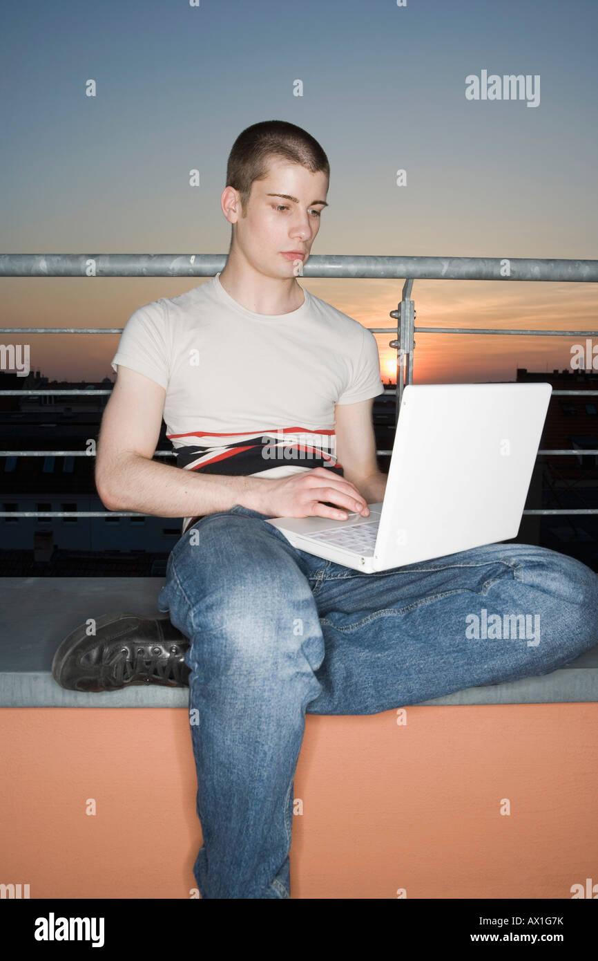 Man sitting on patio using laptop hi-res stock photography and images ...