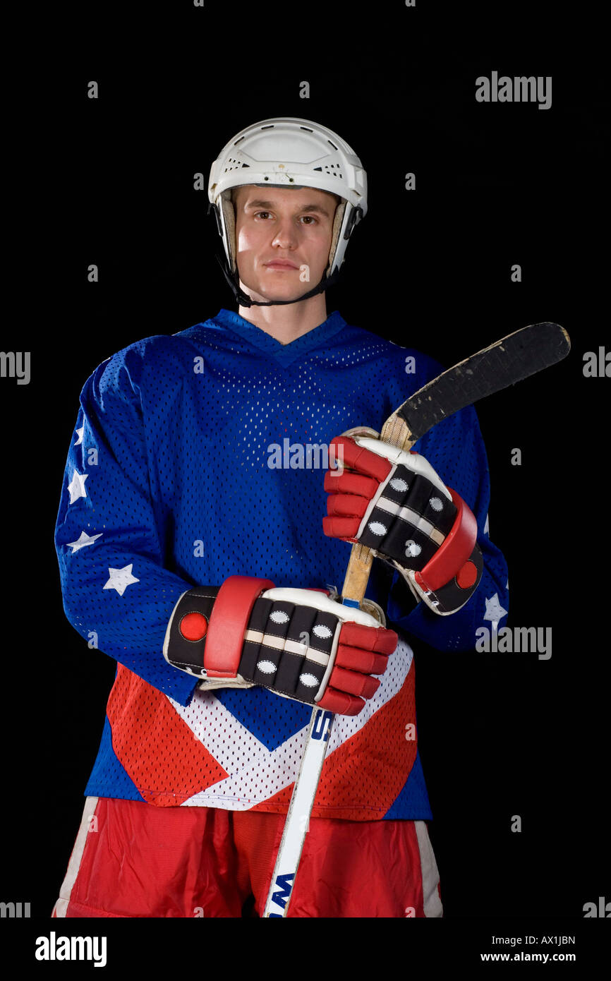 Portrait of male ice hockey player standing at rink Stock Photo - Alamy