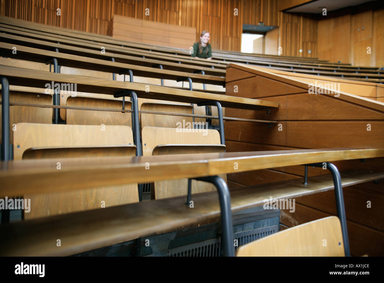 Woman sitting in lecture hall Stock Photo