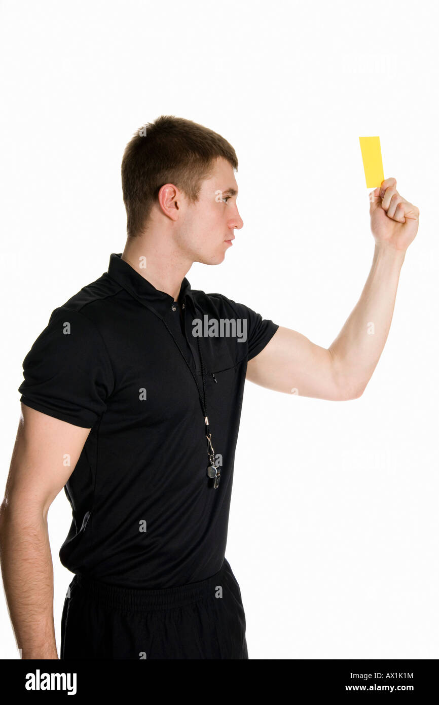 A referee holding up a yellow card Stock Photo Alamy
