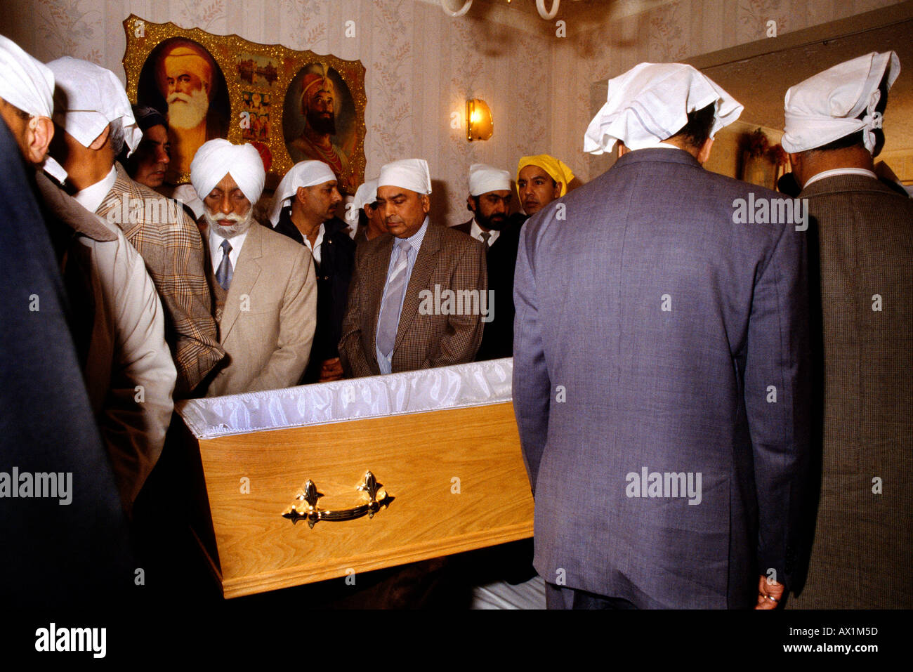 Sikh Funeral Men Filing Past Coffin At Home Stock Photo