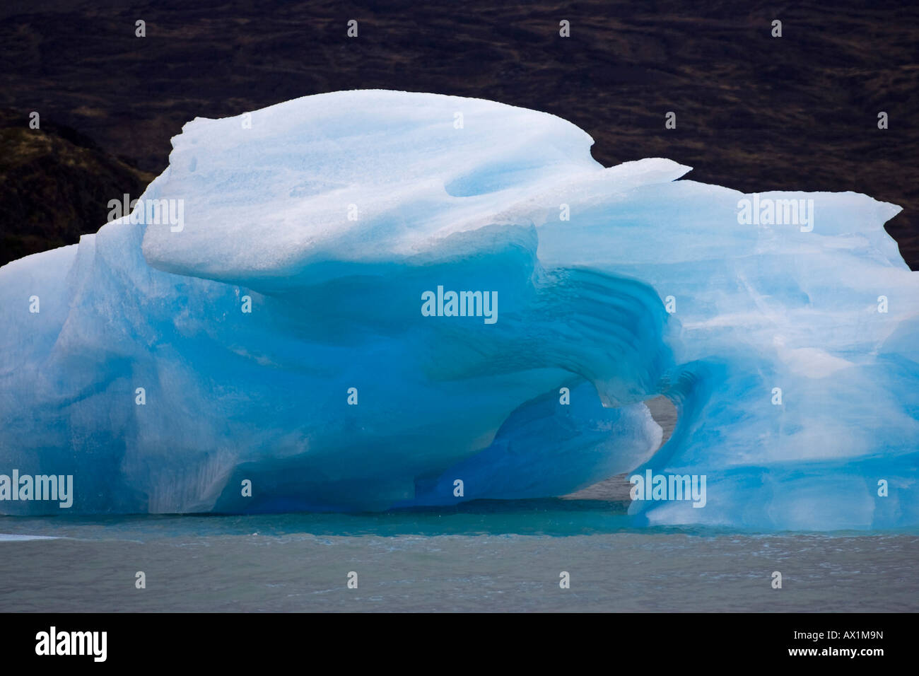 Iceberg with a cave in the lake Lago Argentino, national park Los Glaciares, (Parque Nacional Los Glaciares), Patagonia, Argent Stock Photo