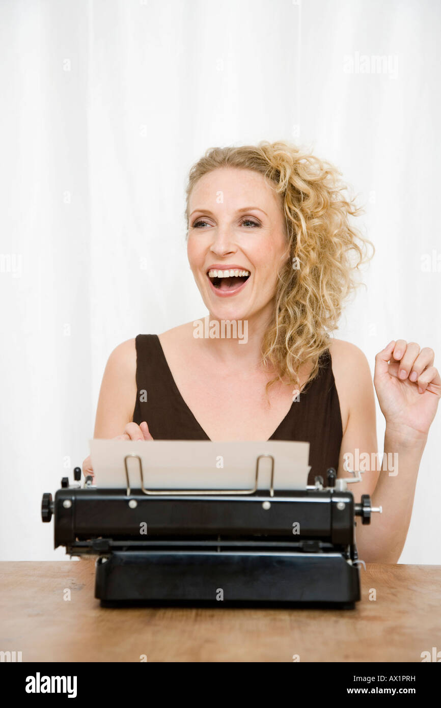 A woman using a typewriter Stock Photo Alamy