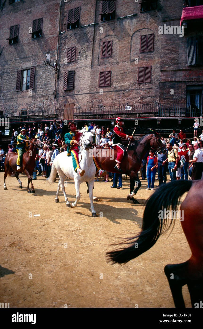 Siena Italy Tourists and Locals watching the Palio di Siena a Horse Raceheld twice a year at the Piazza Del Campo each Jockeys Represents one of the T Stock Photo