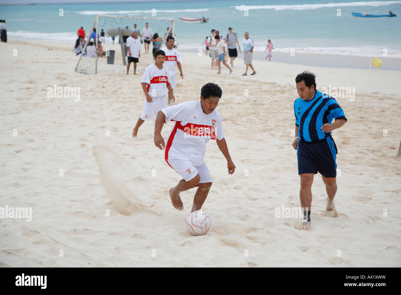 Group of Mexican men playing soccer on the beach, Playa del Carmen