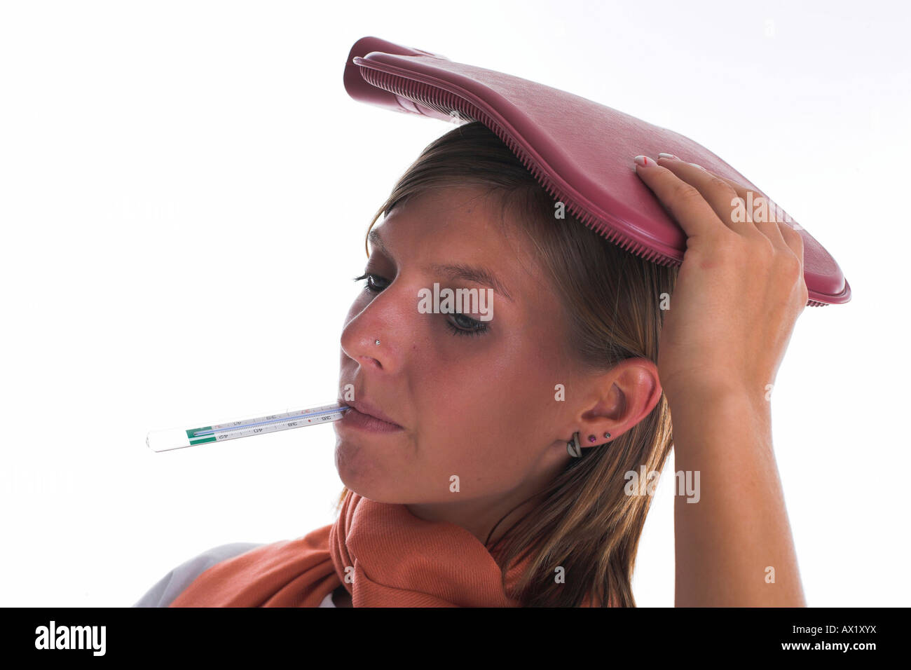 Woman measures the temperature with a thermometer Stock Photo