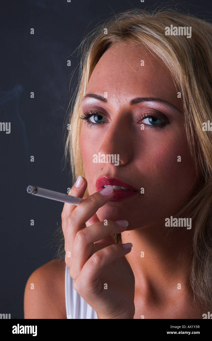 Woman is smoking a cigarette Stock Photo