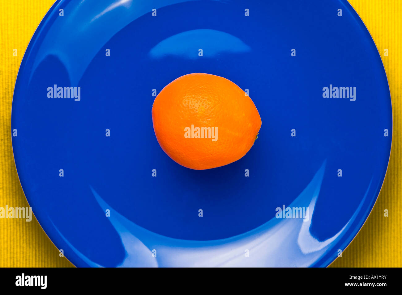 Orange on blue plate Stock Photo
