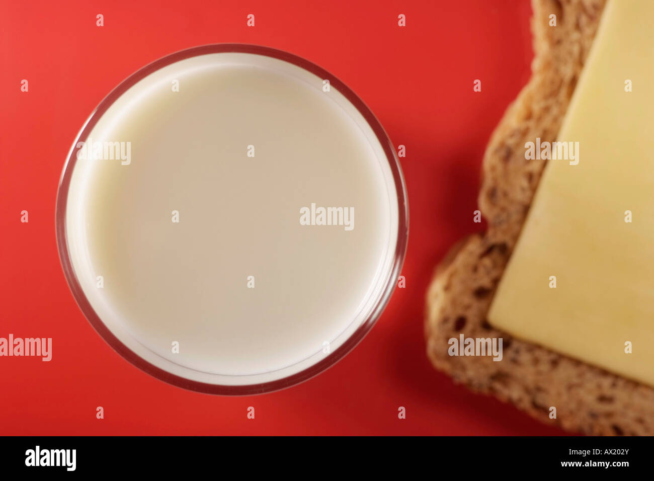 Glass and milk and a slice of bread with cheese Stock Photo