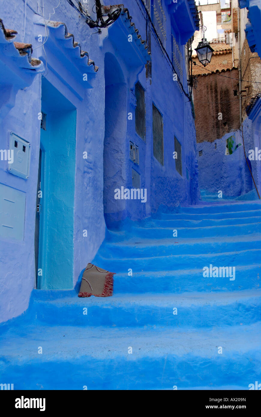 Luminous blue painted steep alley with stairs medina Chefchaouen Morocco Stock Photo