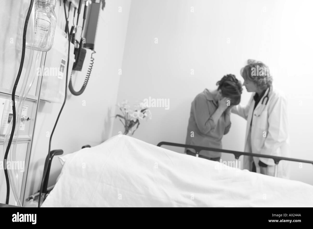 Doctor comforting patient s mother uid 1344285 Stock Photo