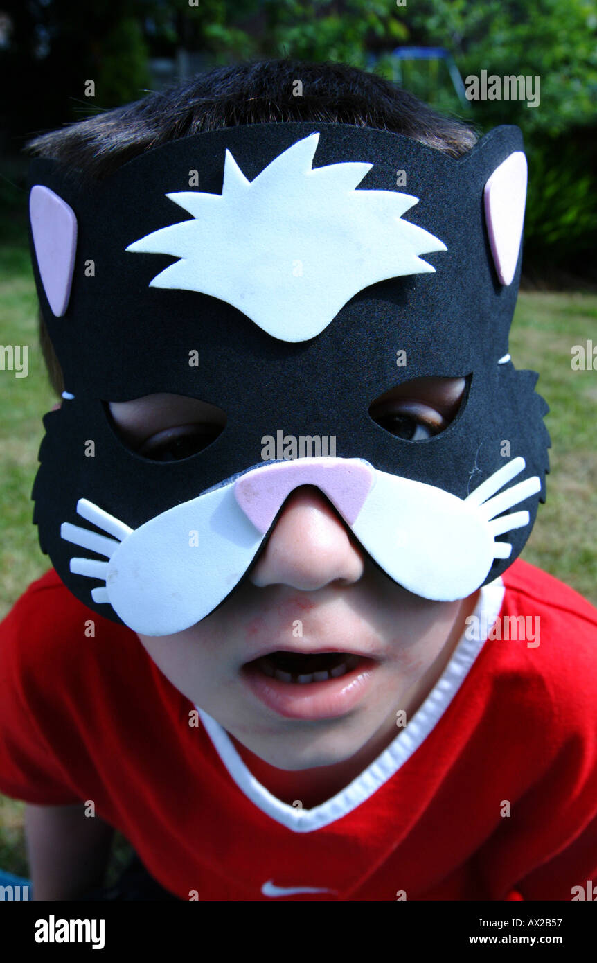 A young boy wearing a cat mask Stock Photo Alamy