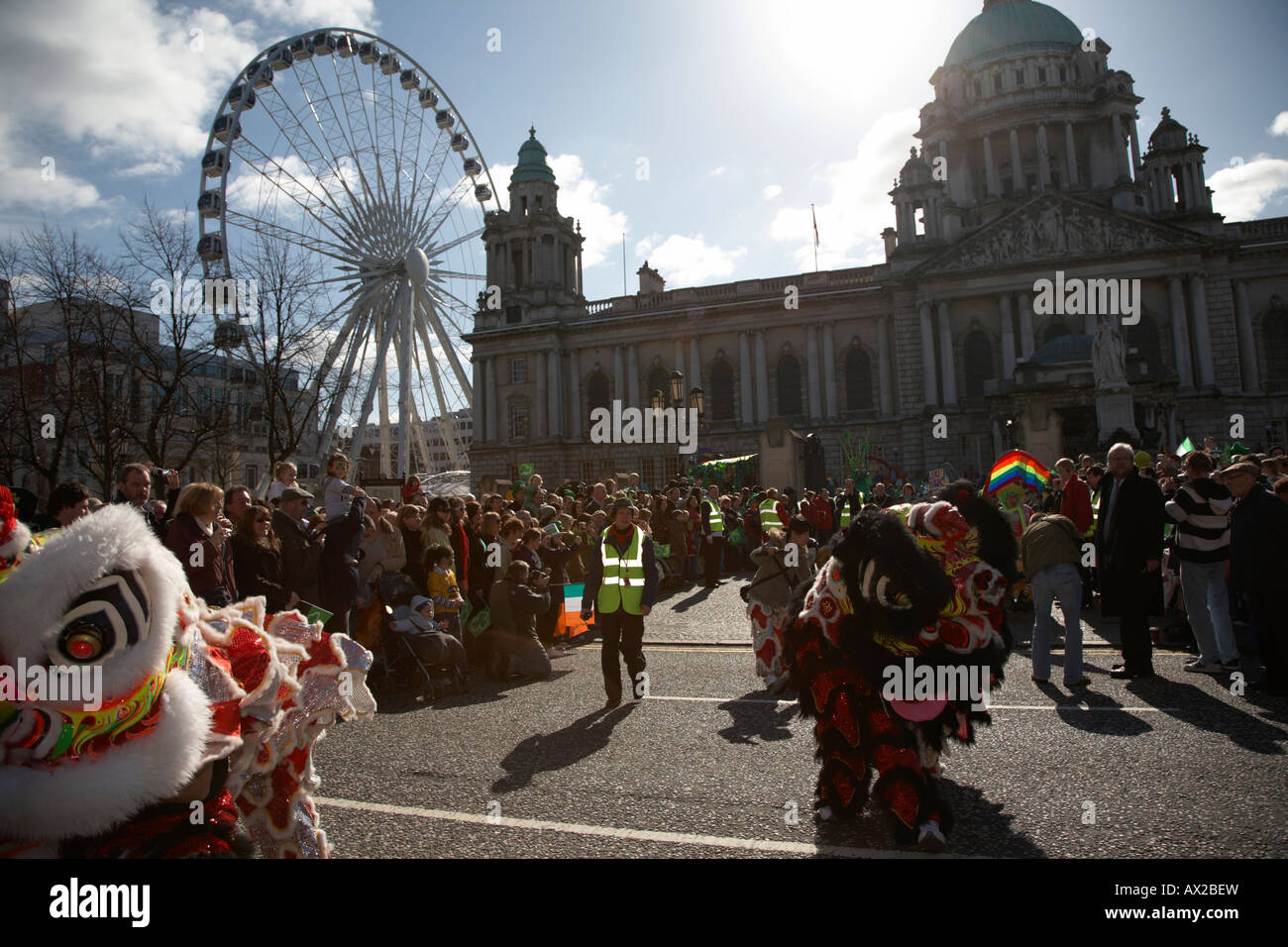 chinese dragons in the parade and carnival in front of belfast city hall and big wheel on st patricks day belfast northern irela Stock Photo