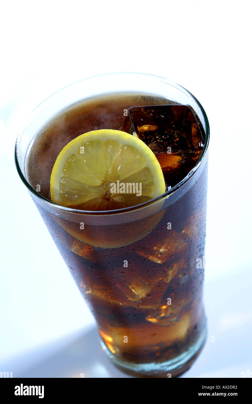 Cola soft drink in a tall glass with ice cubes and lemon slice Stock ...