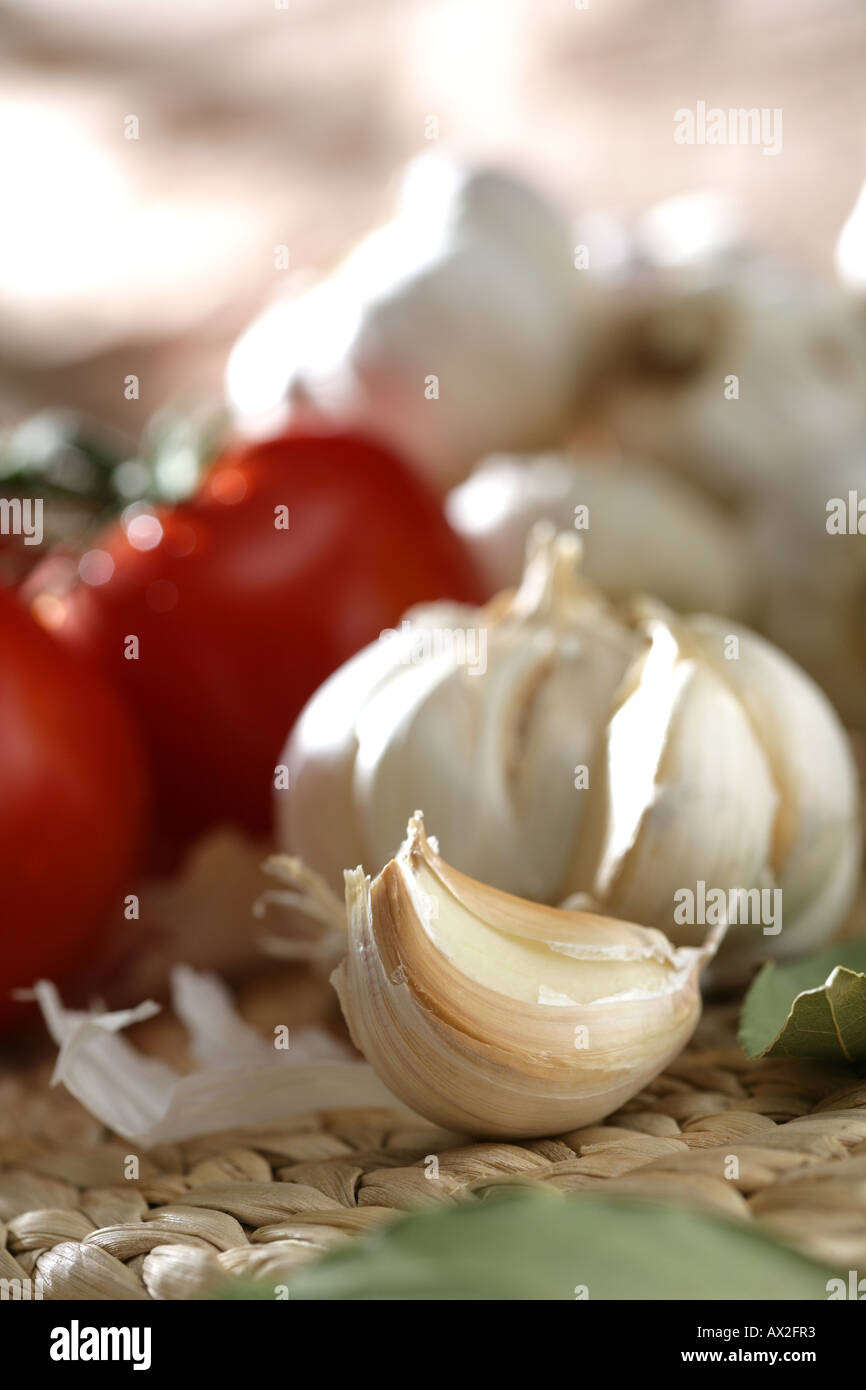 Detail of tomato garlic heads and cloves with natural light Stock Photo ...