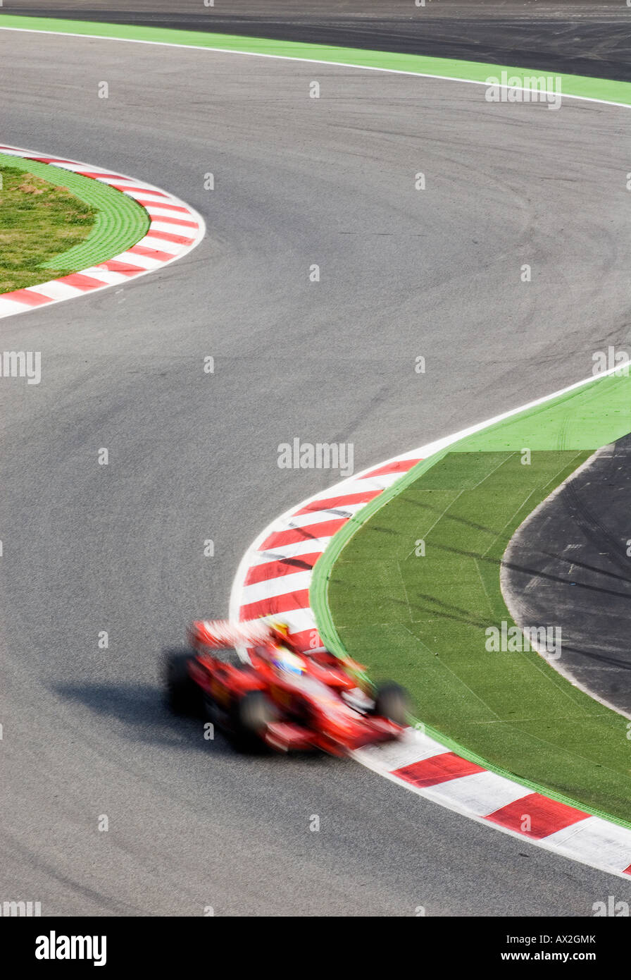 Formula 1 Racecar speeds through double bend curve in racetrack Stock