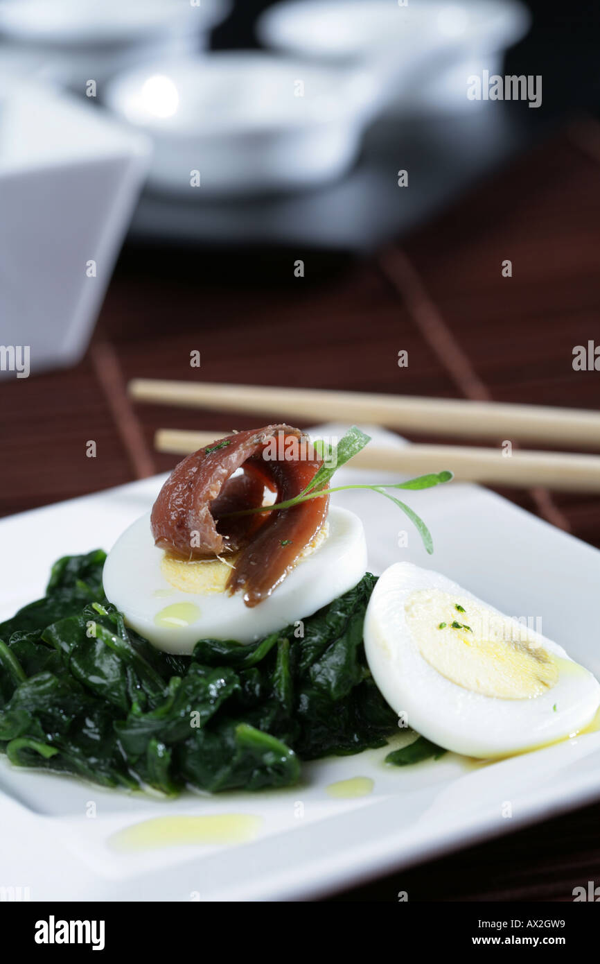 Spinachs with anchovies and hard boiled eggs Stock Photo Alamy